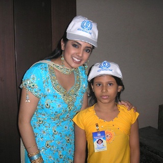 Volunteer and child in Kochi Konther Asar caps